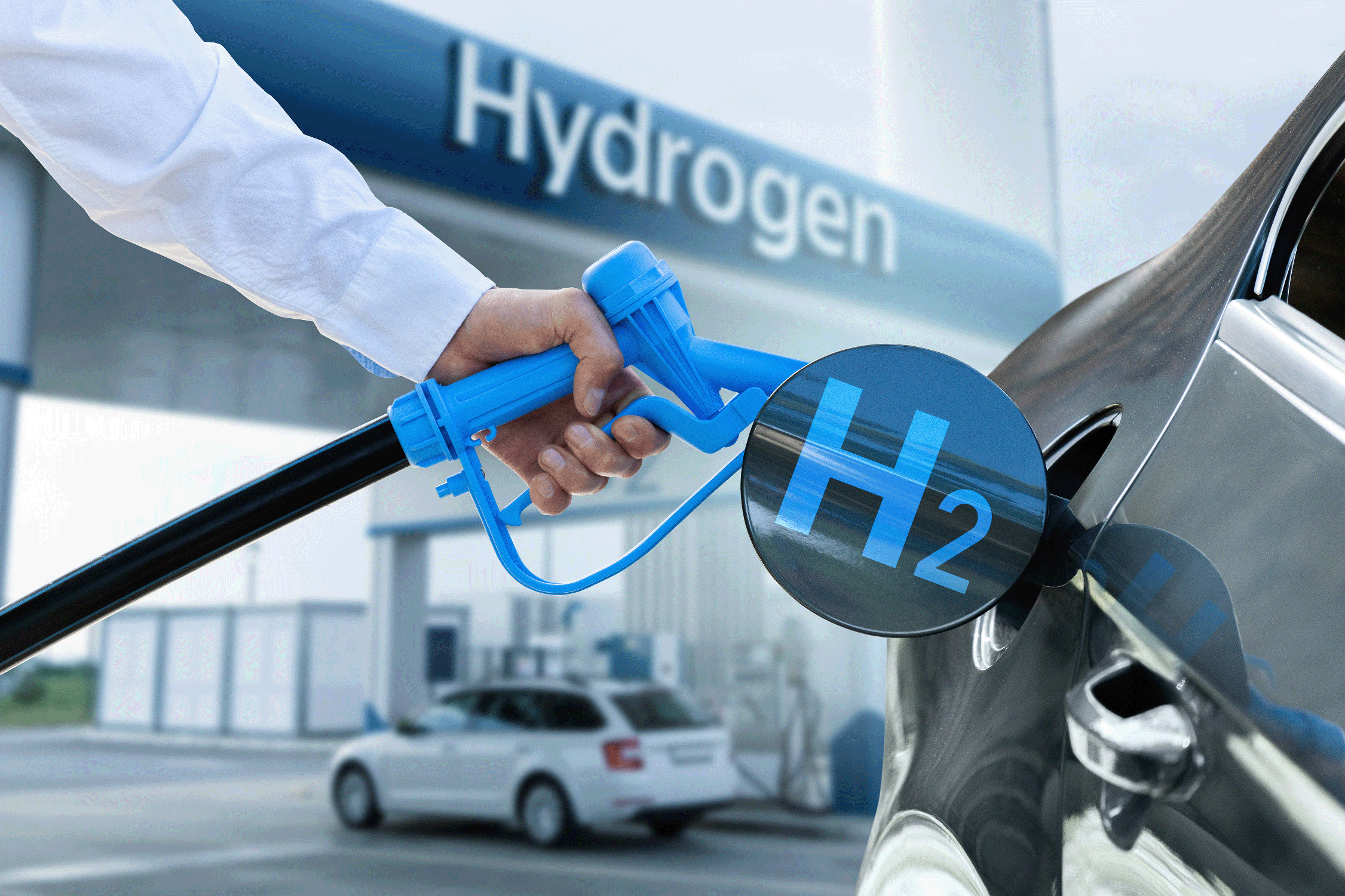 A person fueling a car with Hydrogen